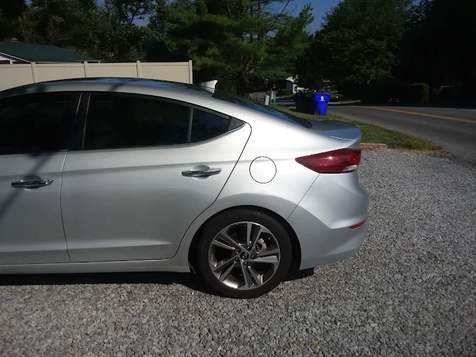 Beautiful deep red sedan with perfect glossy paint finish after body and paint work